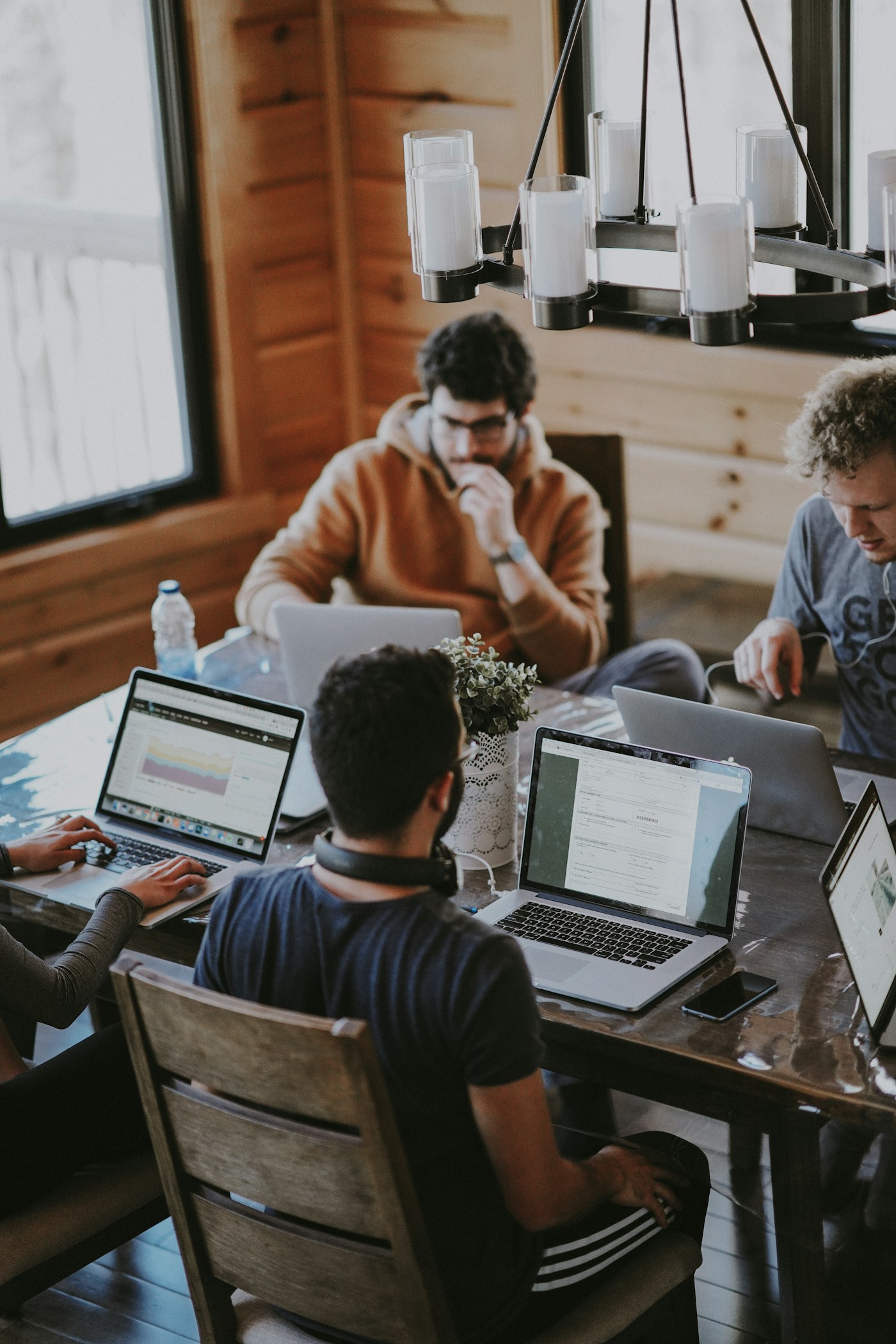 A team working through the day on laptops around a shared table